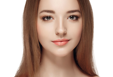 Beautiful woman face close up portrait young. Isolated on white. Studio shot.の写真素材