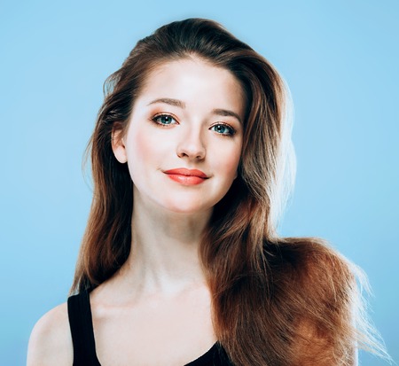 Beautiful woman portrait face on blue background.の写真素材