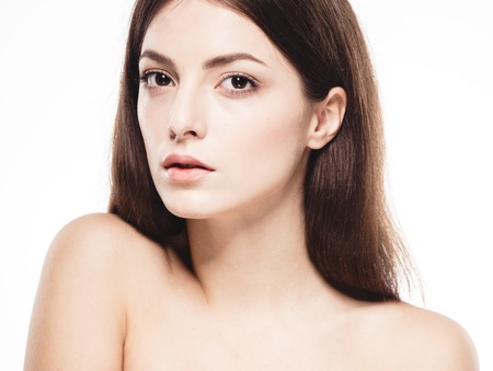 Beautiful woman face close up portrait. Isolated on white.  Studio shot.の写真素材