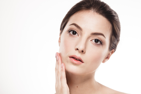 Young beautiful woman face portrait with healthy skin. Studio shot. Isolated on white.の写真素材