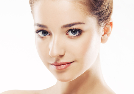 Beautiful woman face close up portrait young. Isolated on white. Studio shot.の写真素材