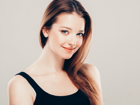 Beautiful woman portrait face. On gray background. Studio shot.の写真素材