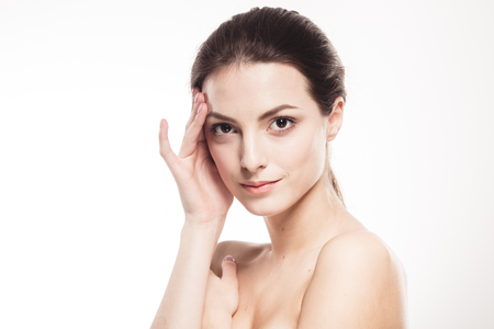 Beautiful woman face close up. Isolated on white. Studio shot.の写真素材
