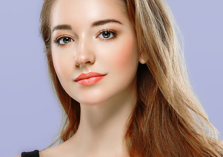 Beautiful woman portrait face on color background. Studio.の写真素材