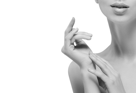 Teeth neck chin hands Beautiful woman portrait face. Isolated on white. black and white. Studio shot.の写真素材