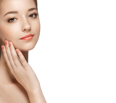 Young beautiful woman face portrait with healthy skin. Isolated on white. Studio shot.の写真素材