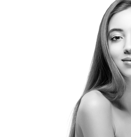 Beautiful woman half-face close up. Isolated on white black and white. Studio shot.の写真素材