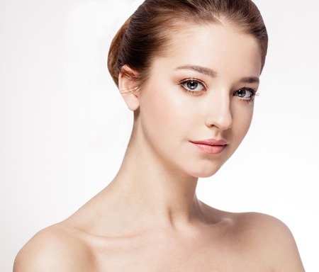Beautiful woman face close up portrait young. Isolated on white. Studio shot.の写真素材