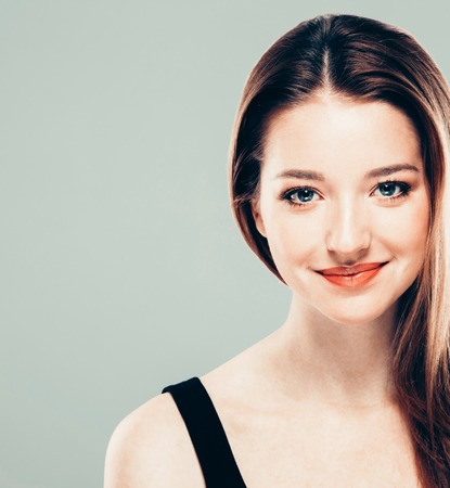 Beautiful young woman portrait smiling posing attractive. Studio shot.の写真素材
