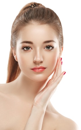 Young beautiful woman face portrait with healthy skin. Isolated on white. Studio shot.の写真素材