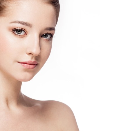 Beautiful woman face close up portrait young. Isolated on white. Studio shot.の写真素材