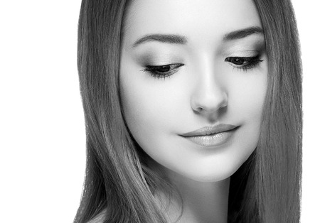 Beautiful woman portrait face. Isolated on white. Black and white. Studio shot.の写真素材