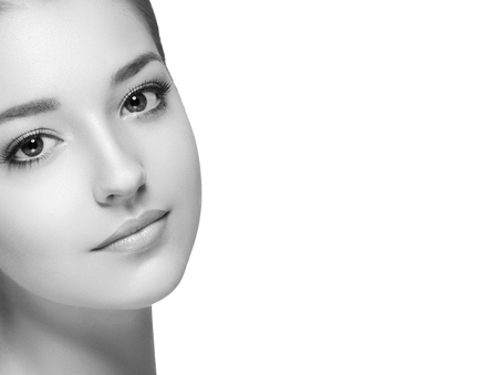 Beautiful woman portrait face. Isolated on white. Black and white. Studio shot.の写真素材