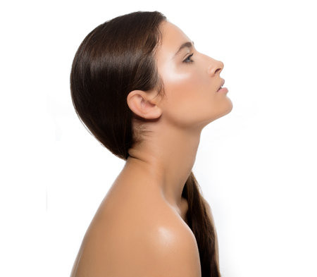Beautiful woman face close up portrait young. Isolated on white. Studio shot.の写真素材