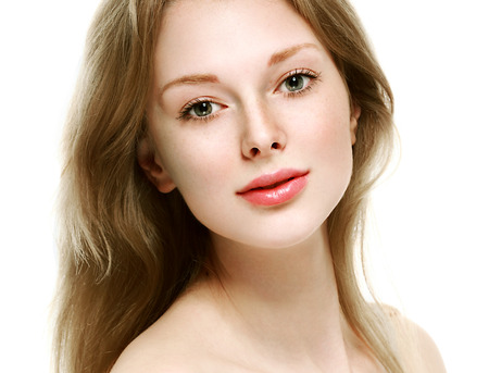 Beautiful woman face close up portrait young. Isolated on white. Studio shot.の写真素材