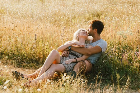 Young and beautiful couple in love together. Summer time. Outdoor shot.の写真素材