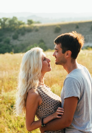 Young and beautiful couple in love together. Summer time. Outdoor shot.の写真素材