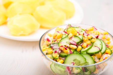 Vegetable salad with corn, boiled potato and cucumbers. Close up view.の写真素材