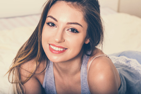 Young woman in bedroomの写真素材