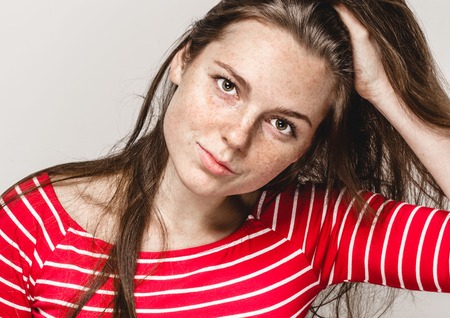 Beautiful young woman portrait with frecklesの写真素材