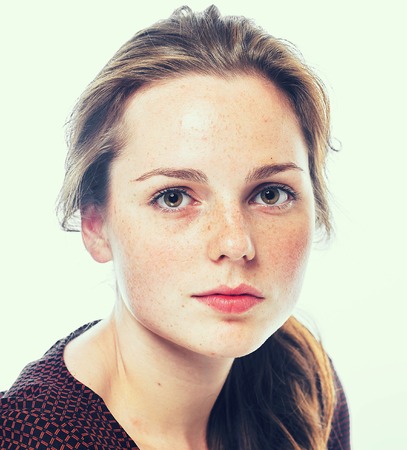 Portrait of young woman with freckles. Isolated on white.の写真素材