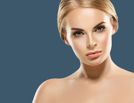 Woman cosmetic closeup beauty portrait, for salon beautiful people and healthy care skin and hair over blue color backgroundの写真素材