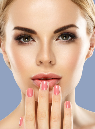 Woman cosmetic closeup beauty portrait, for salon beautiful people and healthy care skin and hair over blue color backgroundの写真素材