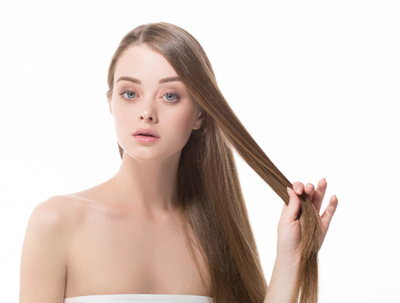 Beauty Girl face Portrait. Beautiful Spa model Woman with Perfect Healthy Hair Smooth. Brunette female looking at camera and smiling. Youth and Skin Care Conceptの写真素材