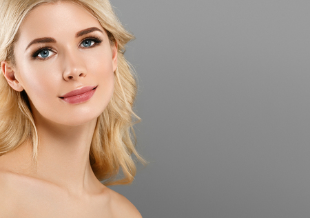 Beauty Woman face Portrait. Beautiful model Girl with Perfect Fresh Clean Skin color lips purple red. Blonde hair Youth and Skin Care Concept.の写真素材