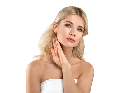 Beautiful Woman Blond face Portrait. Beautiful Spa model Girl with Perfect Fresh Clean Skin. Blonde female smiling. Youth and Skin Care Concept Red Lipstick and nails manicure.の写真素材