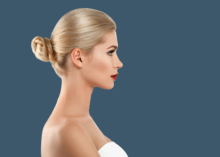 Woman cosmetic closeup beauty portrait, for salon beautiful people and healthy care skin and hair over blue color backgroundの写真素材