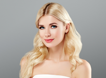 Beauty Woman face Portrait. Beautiful model Girl with Perfect Fresh Clean Skin color lips purple red. Blonde hair Youth and Skin Care Concept.の写真素材