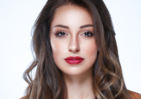 Beautiful Woman Skin Tanned Red Lips Healthy Beauty Skin Smile. Spa Beautiful Model Girl Cute Face over color background.の写真素材