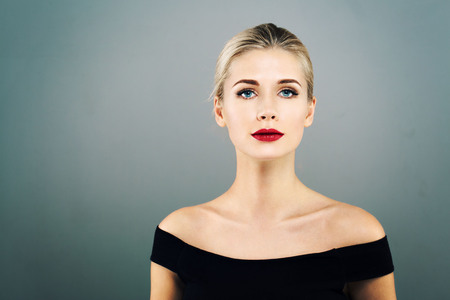 Beautiful Woman Blonde Hairstyle face with red lips portrait. Healthy skin and perfect makeup. Studio shot.の写真素材