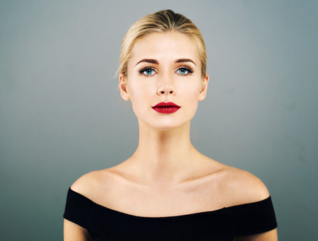Beautiful Woman Blonde Hairstyle face with red lips portrait. Healthy skin and perfect makeup. Studio shot.の写真素材