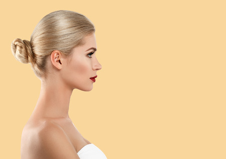 Beautiful profile woman face close up red lips lipstick studio on yellow. Studio shot.の写真素材