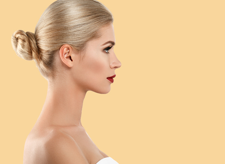 Beautiful profile woman face close up red lips lipstick studio on yellow. Studio shot.の写真素材