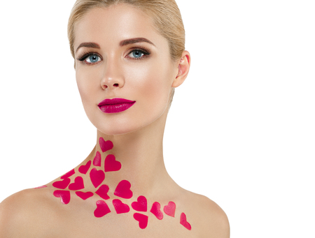 Valentine Day Heart Pink Beauty Woman face Portrait Beautiful Spa model Girl with Perfect Fresh Clean Skin. Blonde model smiling perfect makeup. Isolated on a white backgroundの写真素材