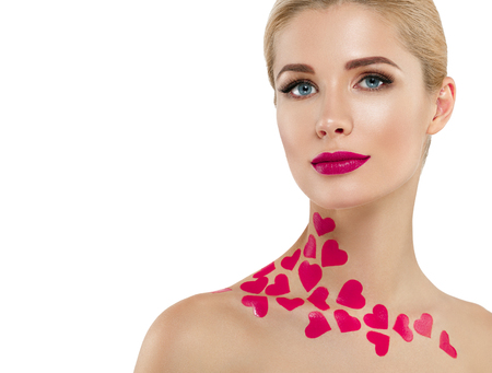 Valentine Day Heart Pink Beauty Woman face Portrait Beautiful Spa model Girl with Perfect Fresh Clean Skin. Blonde model smiling perfect makeup. Isolated on a white backgroundの写真素材
