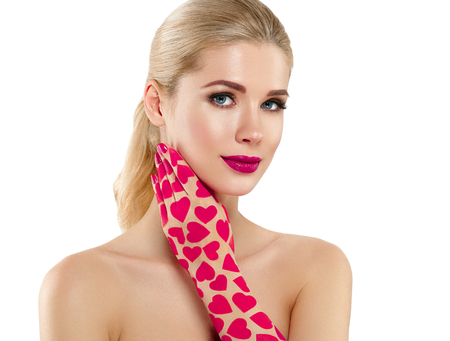 Valentine Day Heart Pink Beauty Woman face Portrait Beautiful Spa model Girl with Perfect Fresh Clean Skin. Blonde model smiling perfect makeup. Isolated on a white backgroundの写真素材