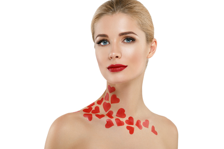 Valentine Day Heart Pink Beauty Woman face Portrait Beautiful Spa model Girl with Perfect Fresh Clean Skin. Blonde model smiling perfect makeup. Isolated on a white backgroundの写真素材
