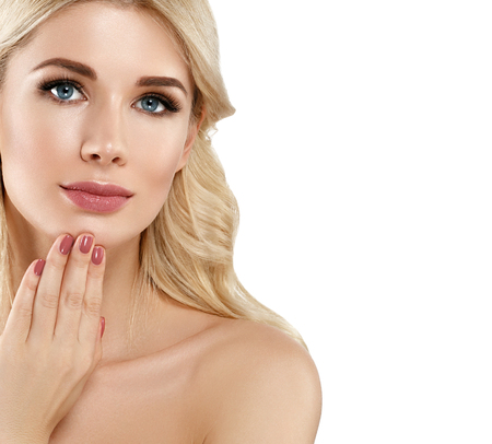Beautiful Woman Blond face Portrait. Beautiful Spa model Girl with Perfect Fresh Clean Skin. Blonde female smiling. Youth and Skin Care Concept Red Lipstick and nails manicure.の写真素材