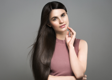 Beautiful perfect hair woman portrait. Studio shot. Gray background.の写真素材