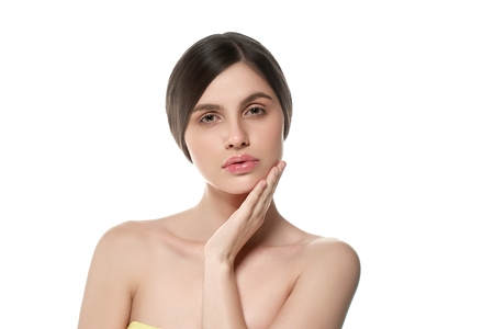 Beautiful Woman Face Portrait Beauty Skin Care Concept Beautiful beauty young female model girl touching her face skin cheeks hands fingers. Fashion Beauty Model isolated on whiteの写真素材