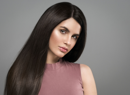 Beautiful perfect hair woman portrait. Studio shot. Gray background.の写真素材