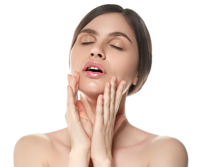 Beautiful Woman Face Portrait Beauty Skin Care Concept Beautiful beauty young female model girl touching her face skin cheeks hands fingers. Fashion Beauty Model isolated on whiteの写真素材