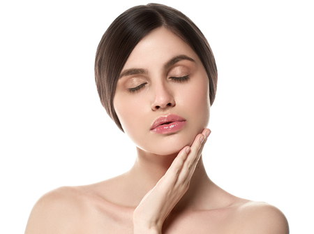 Beautiful Woman Face Portrait Beauty Skin Care Concept Beautiful beauty young female model girl touching her face skin cheeks hands fingers. Fashion Beauty Model isolated on whiteの写真素材