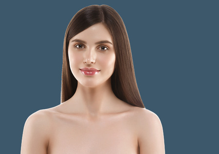 Woman cosmetic closeup beauty portrait, for salon beautiful people and healthy care skin and hair over blue color backgroundの写真素材