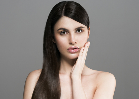 Beautiful perfect hair woman portrait. Studio shot. Gray background.の写真素材