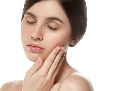 Beautiful Woman Face Portrait Beauty Skin Care Concept Beautiful beauty young female model girl touching her face skin cheeks hands fingers. Fashion Beauty Model isolated on whiteの写真素材